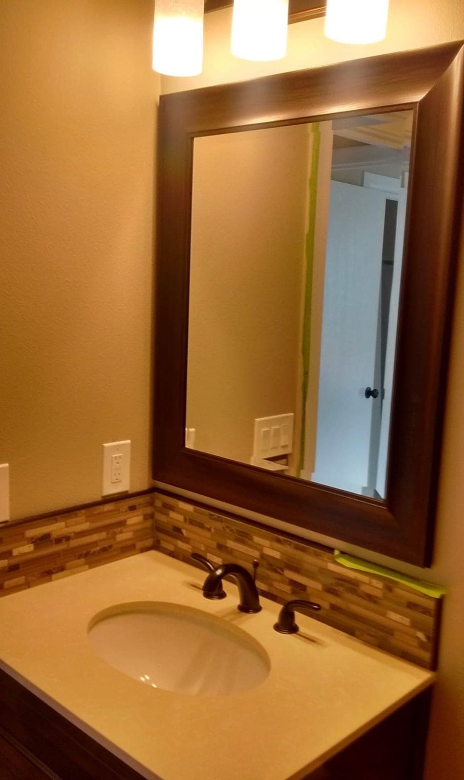Vanity, mirror and tile backsplash